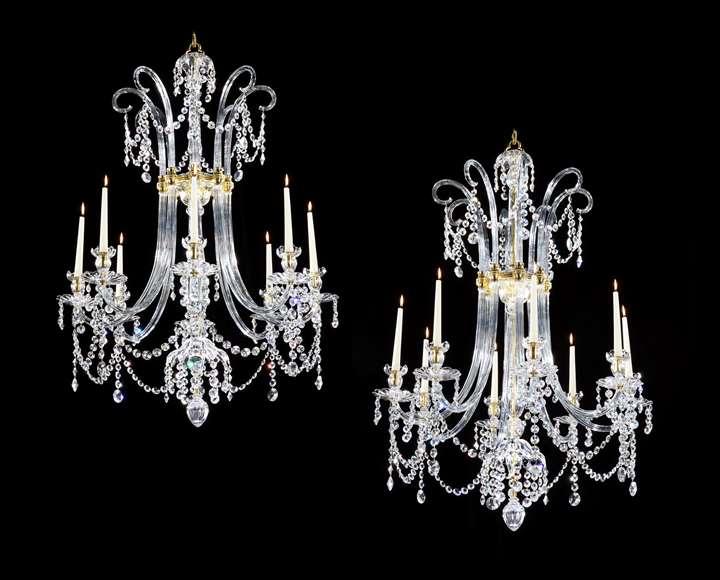 A PAIR OF GEORGE III SIX LIGHT ORMOLU MOUNTED CUT GLASS CHANDELIERS